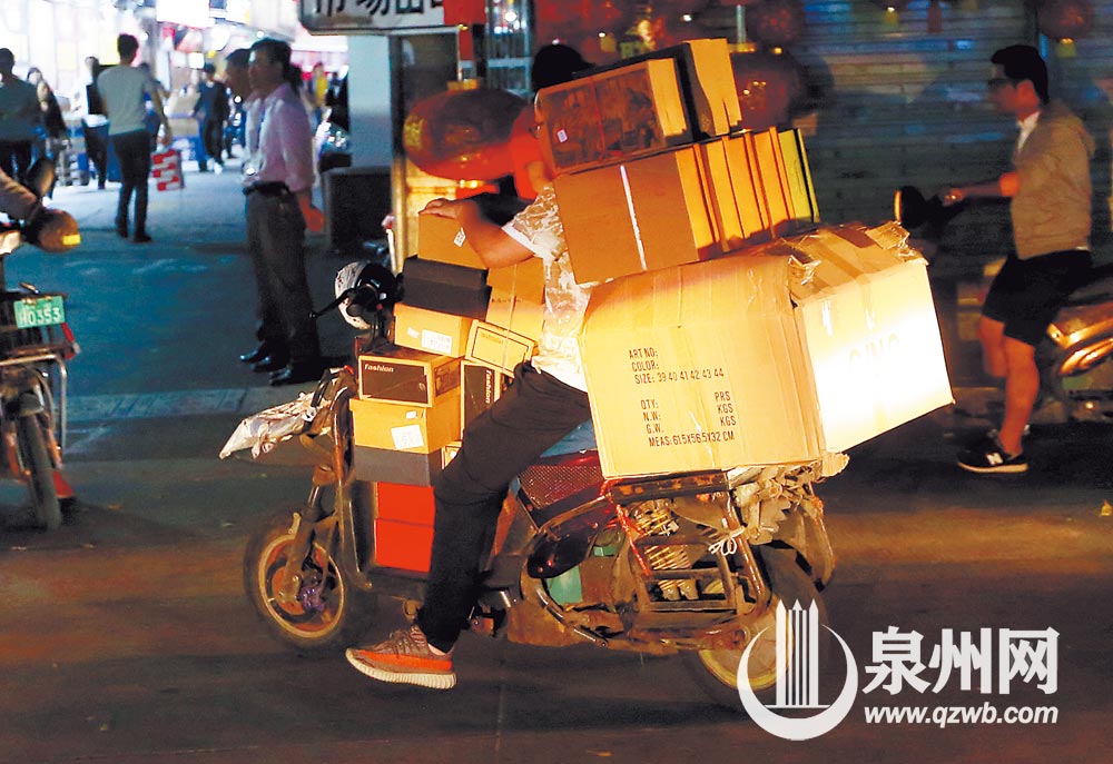 电动车载满了快件，已经看不到人了。