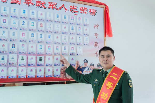 【13】吴进军在标有自己名字、照片的仙塘社区为国奉献军人光荣榜前留影。 【13】吴进军在标有自己名字、照片的仙塘社区为国奉献军人光荣榜前留影。