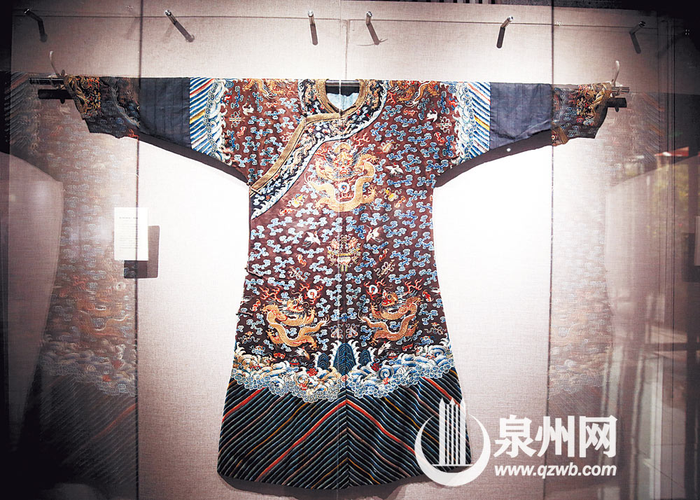 清朝明黄色纳纱地十二章纹女龙袍，据说是慈禧所穿的女吉服龙袍，绣有日、月、星辰、山、龙、粉米等12个吉祥符号。