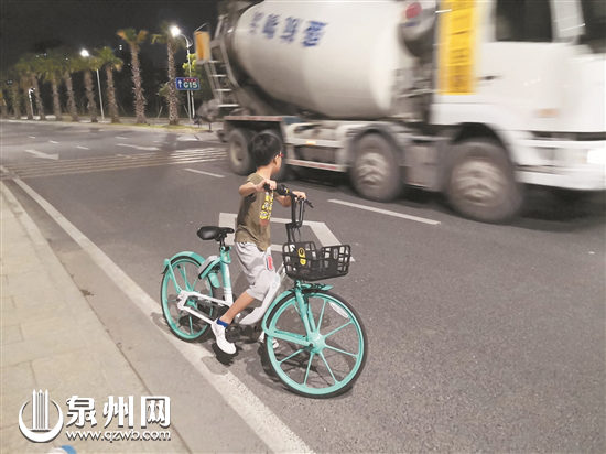 小孩骑共享单车上街
