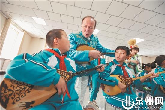 阿什里乡中心学校的孩子们在泉州援建的教学楼内弹奏冬不拉